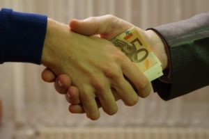 a handshake with money