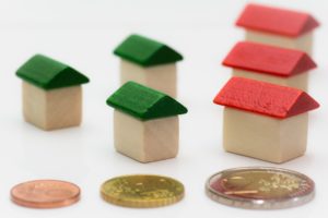 coins and house miniatures